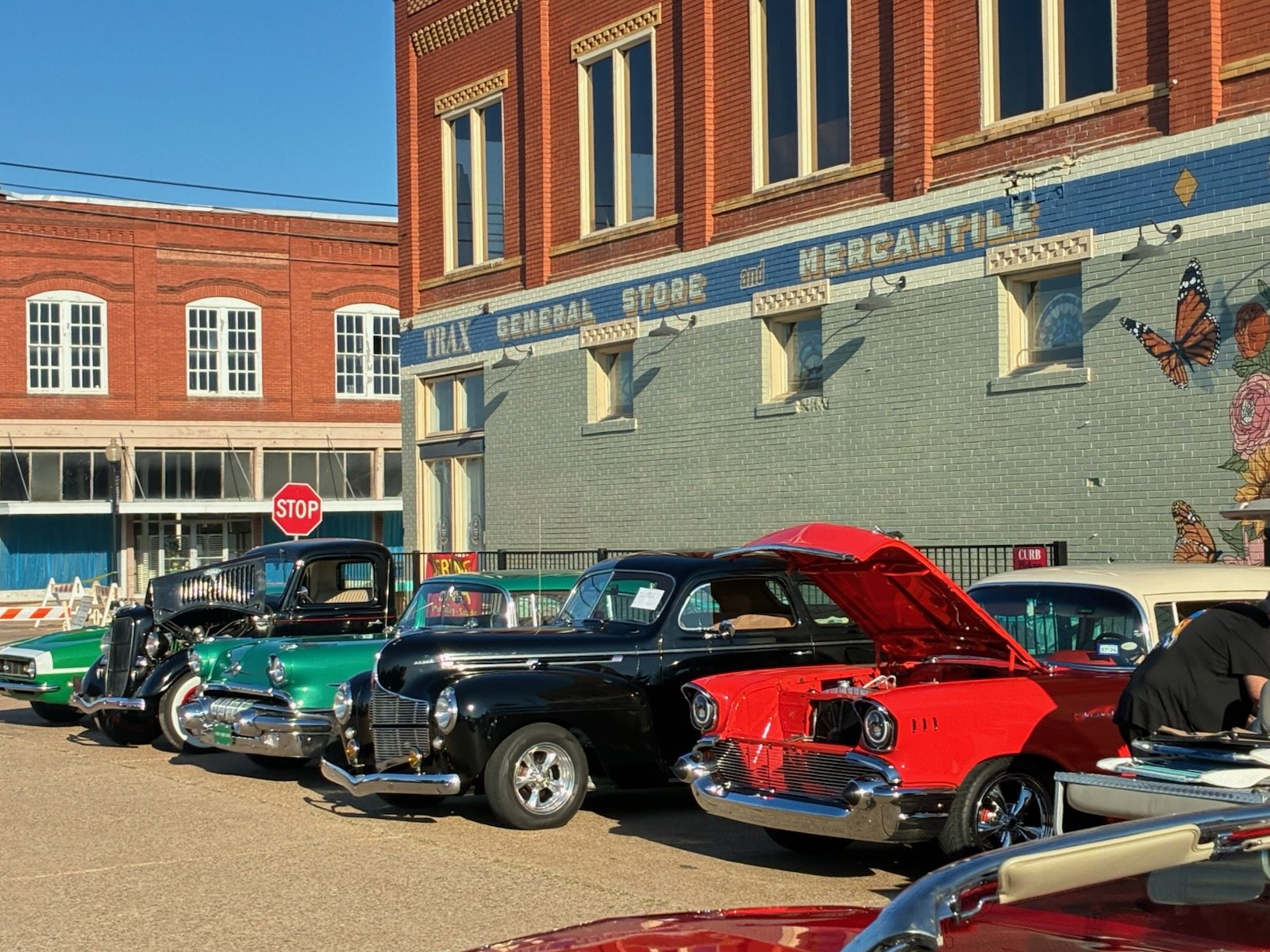 Classic cars lined up at the car show by the Trax General Store building